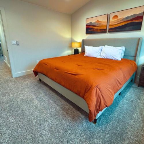 The primary bedroom features a king bed, a beautiful en suite bathroom, and a walk-in closet accessed through the bathroom.