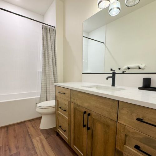 Bedrooms #3 and #4 share a full bathroom upstairs, which includes a vanity and a tub/shower.