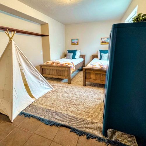 Bedroom #5 comes with two twin beds and some fun decor — perfect for kids!