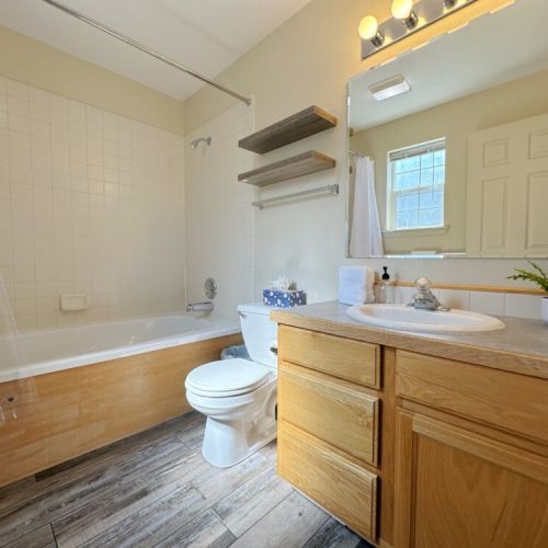 The master en suite features a vanity and a lovely tub/shower combo.