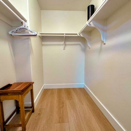 The primary bedroom features a queen bed, walk-in closet, large desk, direct access to the backyard, and a beautiful en suite bathroom.