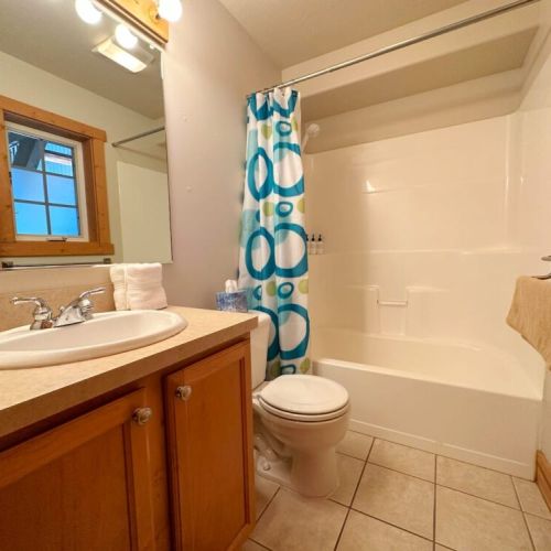 The downstairs bathroom has a large tub/shower combo and a great mirror for beginning or ending your day.