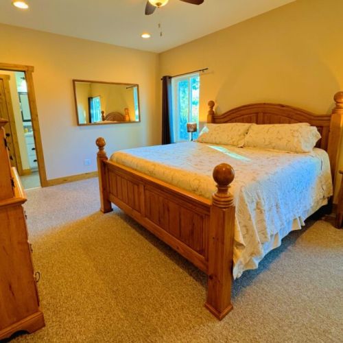 The primary bedroom features a king bed, a large en suite bathroom, and a walk-in closet.