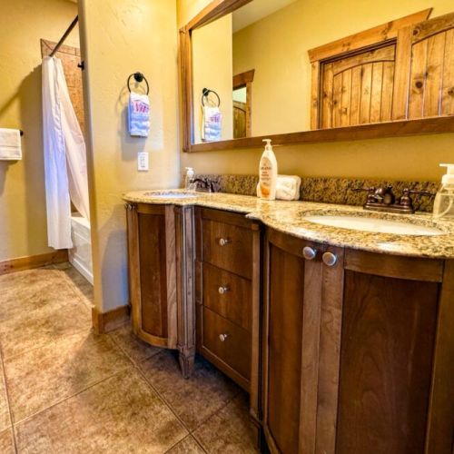 The en suite bath comes with a double vanity, large tub/shower combo, and a spacious closet.