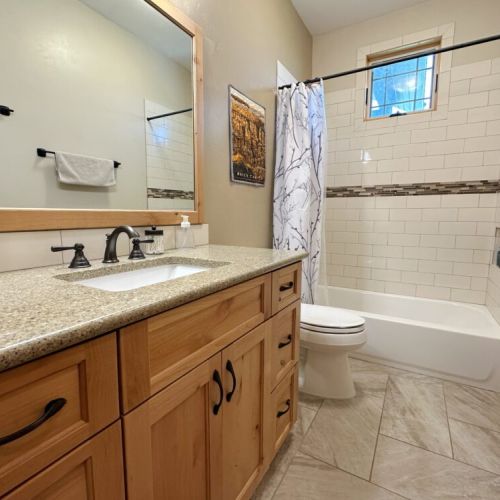 The main level full bathroom has a tub/shower combo and a large vanity.