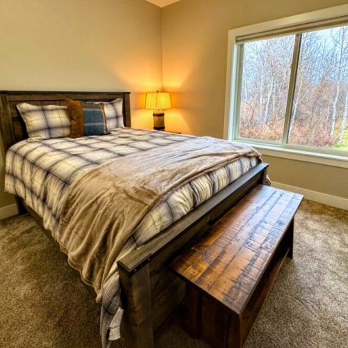 Bedroom #2 has a queen bed and a lovely view of the front yard.