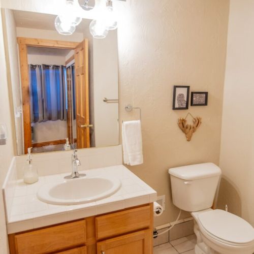 Down in the basement, bedroom #3 enjoys a twin-over-full bunk bed and an attached half-bath, as well as a TV — perfect for kids!