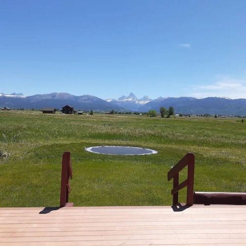 Playing on an in-ground trampoline in the shadow of the Tetons is a one-of-a-kind experience for kids (and adults, too)!