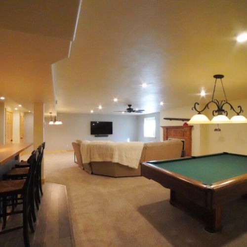 In the basement is another living space, complete with a bar, gas fireplace, and pool table.
