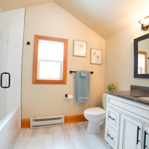 The upstairs bathroom has a large tub/shower condo and a lovely modern vanity.