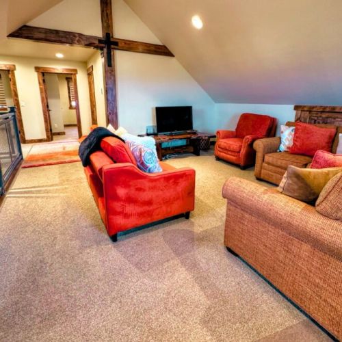 The upstairs features another common area, a pullout sofa bed, and a desk for work- or school-from-home.