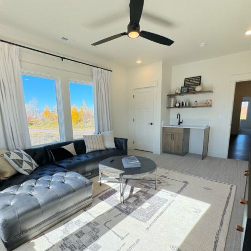 Also located upstairs is a beautiful sitting room, with tremendous natural light, an enormous TV, and a small wet bar.