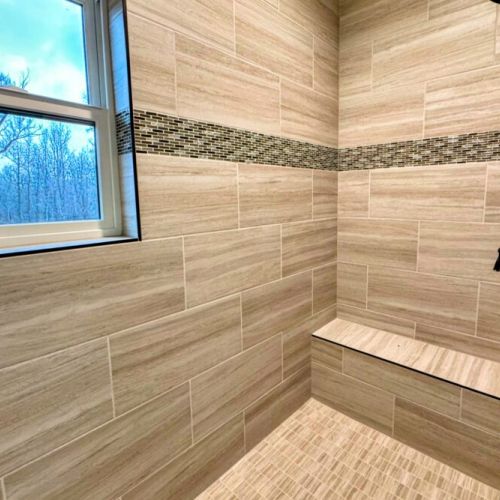 The primary en suite enjoys a spacious double vanity, a luxurious step-in shower, and access to the walk-in closet.