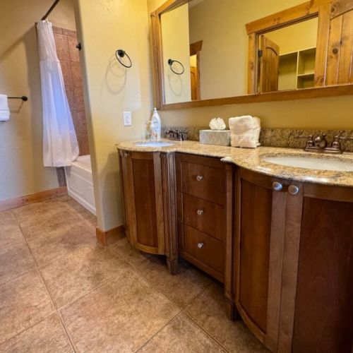 The en suite bath comes with a double vanity, large tub/shower combo, and a spacious closet.