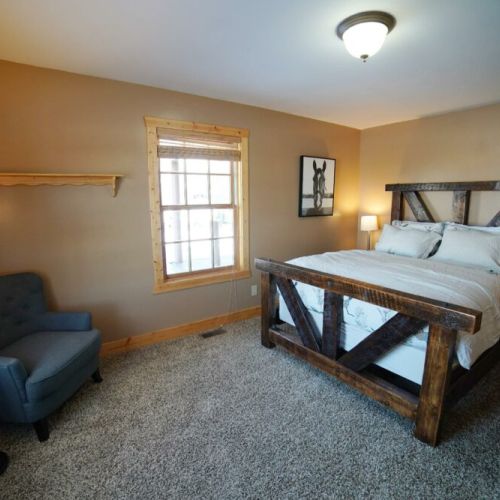 Bedroom #3 on the main floor also enjoys a great queen bed with a custom-made wood frame, as well as a spacious closet.
