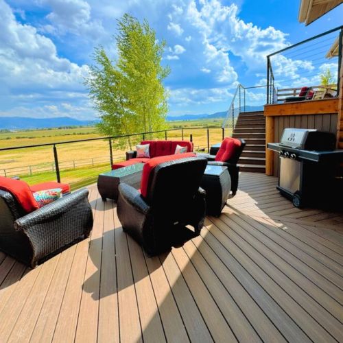 The expansive back deck is the perfect place to hang out with family, cook on the grill, and enjoy the spectacular view.