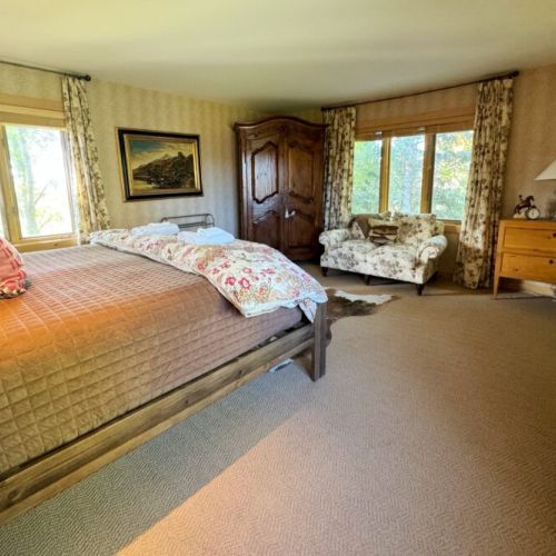 The master bedroom has a king bed, lovely sitting space,  a walk-in closet, and an en suite bath.