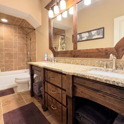 Bedrooms #2 and #3 share a full bathroom with the downstairs living area — it has a large double vanity as well as a tub/shower combo