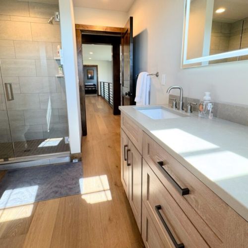 The Jack-and-Jill-style bathroom features a double vanity and a walk-in shower.