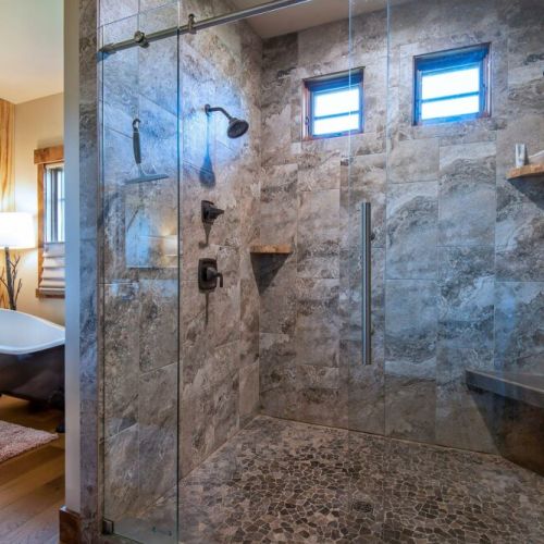 The master bath has a walk-in shower with his-and-hers shower heads. There is also a beautiful tub, three sinks, and plenty of space to store toiletries or other items.