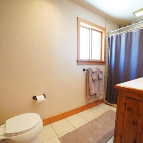 Just outside of bedroom #2's door is a full bath, complete with a vanity and shower/tub combo.