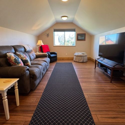 Over the garage is a separate living area — perfect for kids or those in need of a little getaway!