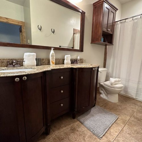 This bathroom, shared by bedrooms #2 and #3, has large tub/shower combo and a double vanity.