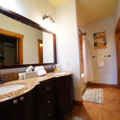 The en suite bath comes with a double vanity, large tub/shower combo, and a spacious closet.
