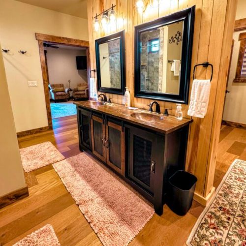 The master bath has a walk-in shower with his-and-hers shower heads. There is also a beautiful tub, three sinks, and plenty of space to store toiletries or other items.