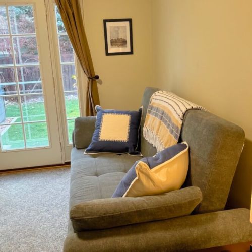 Bedroom #4 (Main Level) has a comfortable sofa that can be folded out into a queen-sized bed. It also enjoys direct access to the backyard, including the hot tub and propane BBQ.