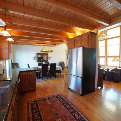 Whether you are relaxing in the living room, eating at the dining room table, or hanging in the kitchen, you are always a part of the fun in this home.