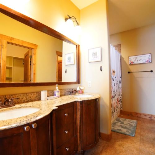 The en suite bath comes with a double vanity, large tub/shower combo, and a spacious closet.