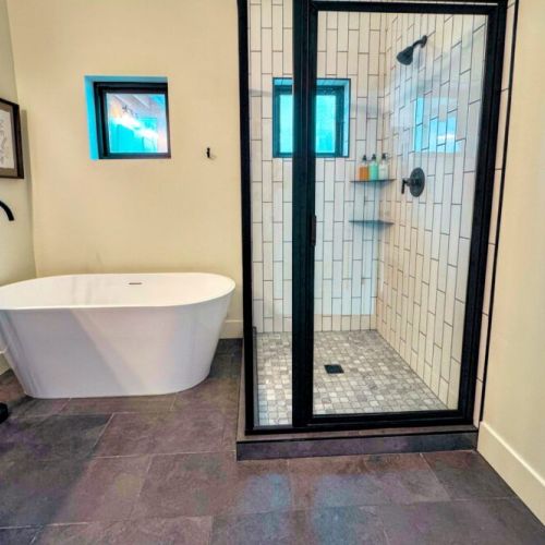 The primary en suite enjoys a large walk-in shower, a soaking tub, and a spacious double vanity.