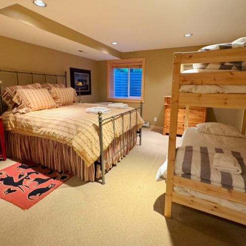 Bedroom #5, located in the basement, has a queen bed, twin-over-twin bunk bed, and an en suite bath.