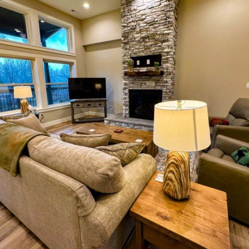Relax in the living room after a day of play by lounging on the sofa or recliners in front of the gas fireplace or smart TV.