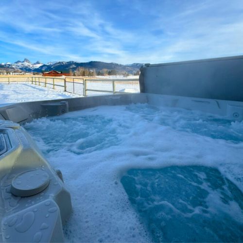 Enjoy spectacular views of the Tetons while you unwind in the luxurious hot tub.