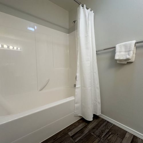 The main level hall bath features a vanity and a large tub/shower combo.