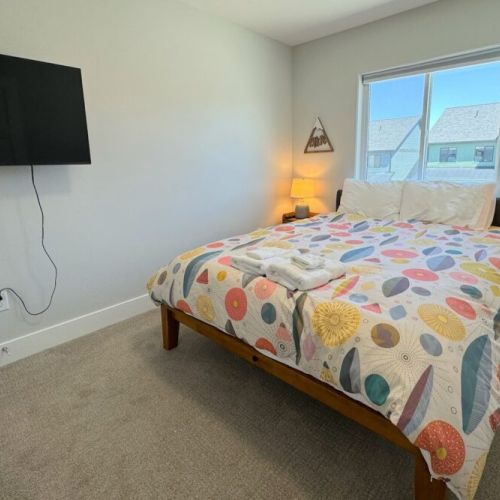Bedroom #2 has a comfy queen bed, its own TV, and a roomy closet.