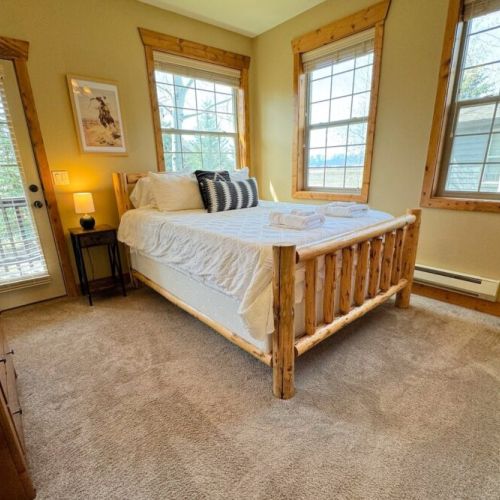 Bedroom #2 has a comfy queen bed with a large closet, a set of drawers, and great natural light.
