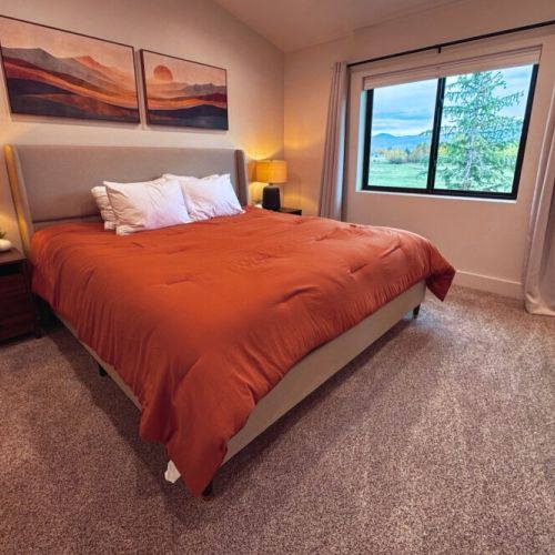 The primary bedroom features a king bed, a beautiful en suite bathroom, and a walk-in closet accessed through the bathroom.