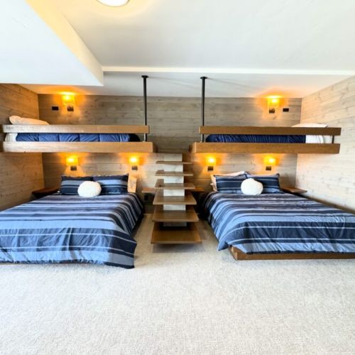 Bedroom #4, located on the lower level, features two custom twin-over-queen bunks. But these aren't your average bunk beds — the sturdy construction and space allows for people of all ages to use them comfortably.