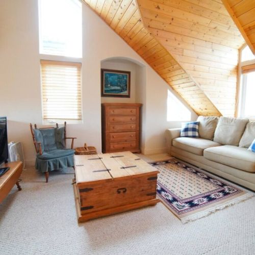 The master bedroom, located on the 3rd floor, features a king bed, its own sitting area with a TV, and an en suite bathroom.