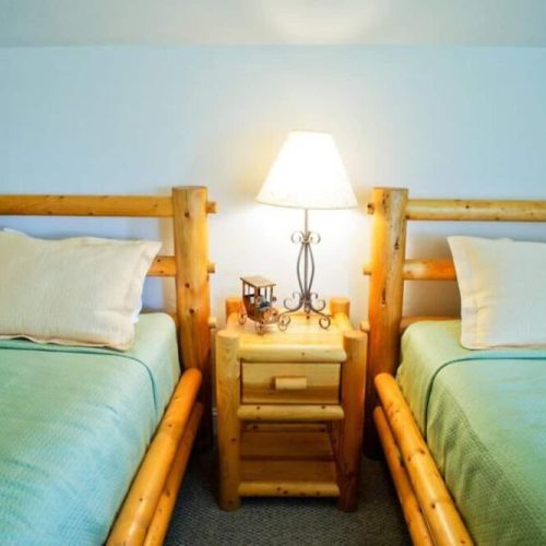 The third floor loft room features high ceilings and a cozy living area, as well as two twin bedrooms and an attached bathroom.