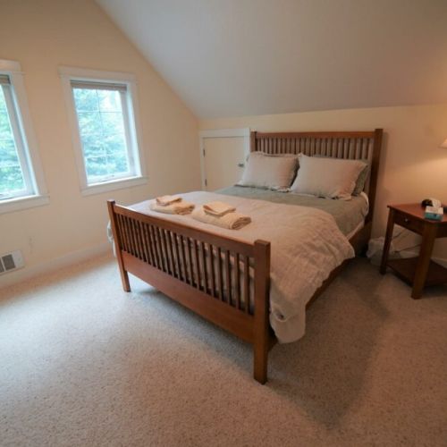 Upper bedroom has a queen bed and direct access to upper full bath.