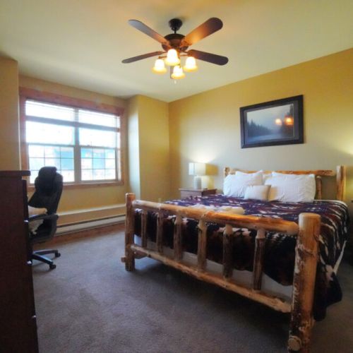 The master bedroom enjoys a king bed, an en suite bath, its own TV, and a sit-stand desk.