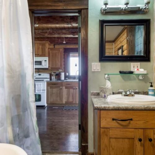 The shared full bathroom is located on the main floor of the home, enjoying a tub/shower and a vanity.