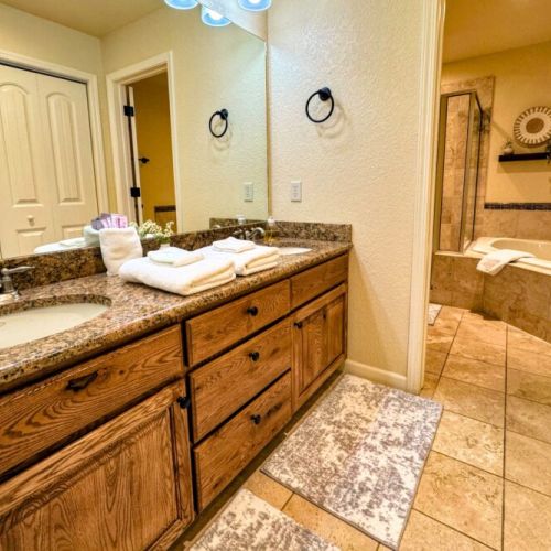 The primary en suite enjoys a spacious double vanity, a walk-in shower, and a large tub.