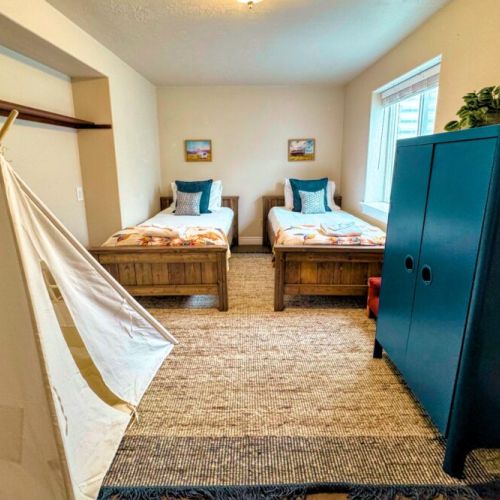 Bedroom #5 comes with two twin beds and some fun decor — perfect for kids!