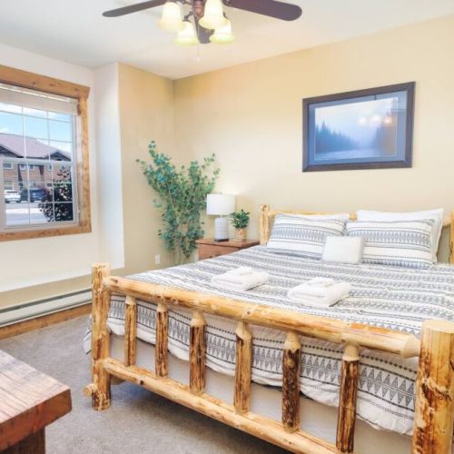 The primary bedroom enjoys a king bed, an en suite bath, its own TV, and a sit-stand desk.