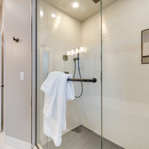 The primary en suite enjoys a spacious double vanity, a luxurious step-in shower, and a soaking tub.